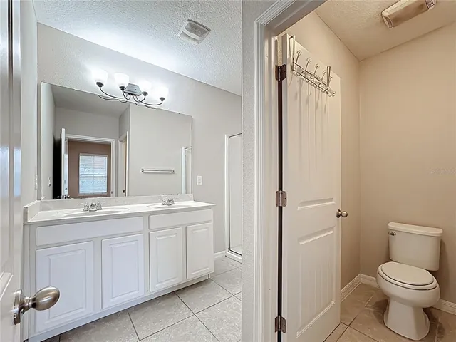 a bathroom with a shower sink and mirror