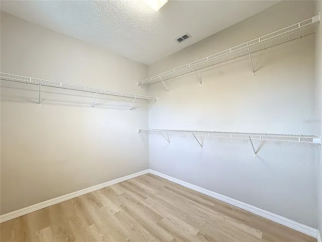 a view of a room with rack on the wall and a window