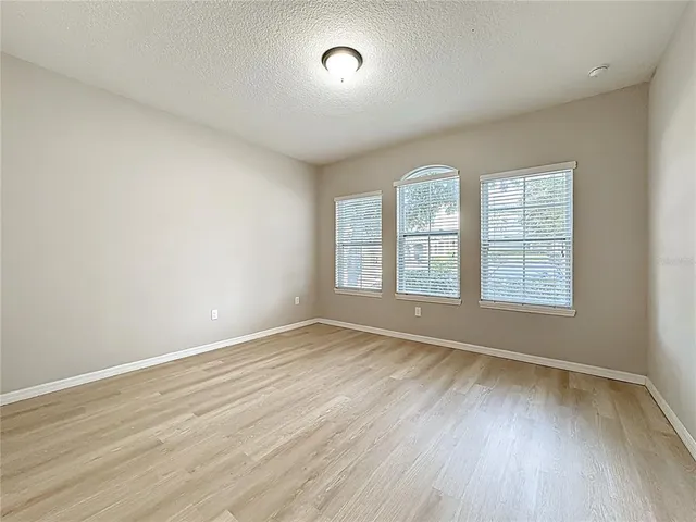 a spacious bedroom with a bed and a large window
