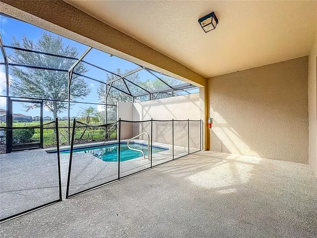 an aerial view of residential houses with outdoor space and lake view