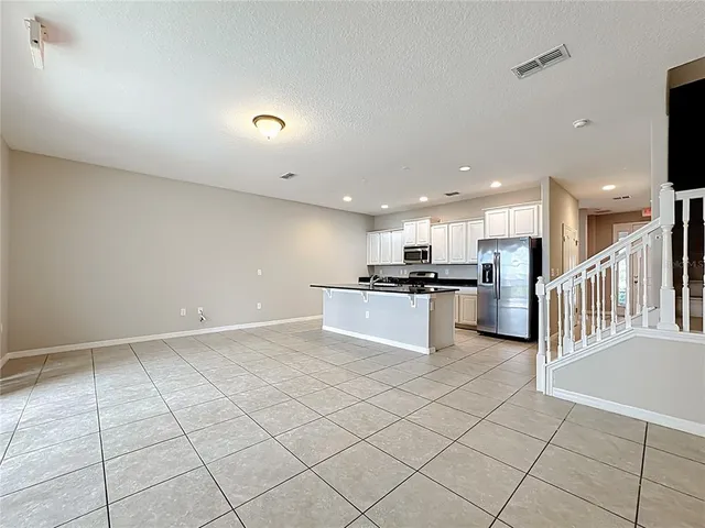a kitchen with granite countertop cabinets and steel stainless steel appliances