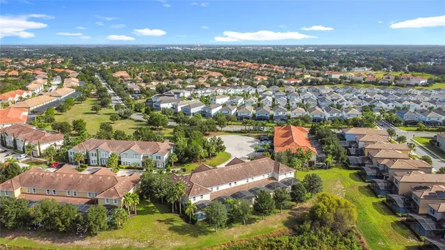 an aerial view of residential house with swimming pool and lawn chairs