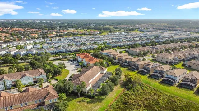 a view of a swimming pool with lawn chairs and plants