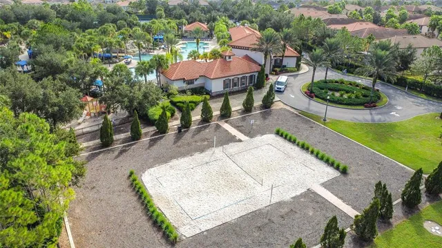 an aerial view of a house with a yard and potted plants