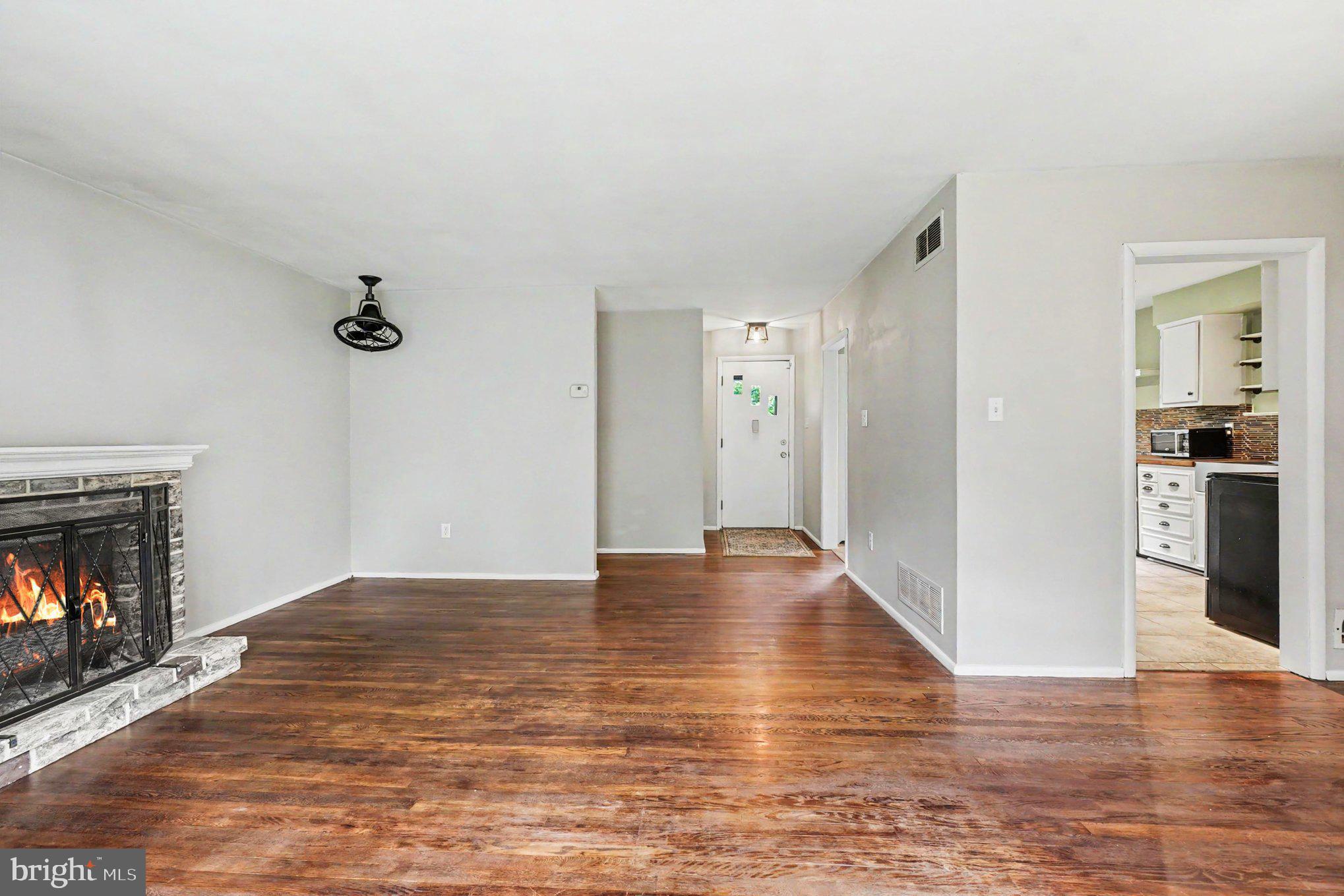 201 Mountain Road Fallston, MD 21047 - Photo 5 of 35 a view of empty room with wooden floor and fireplace