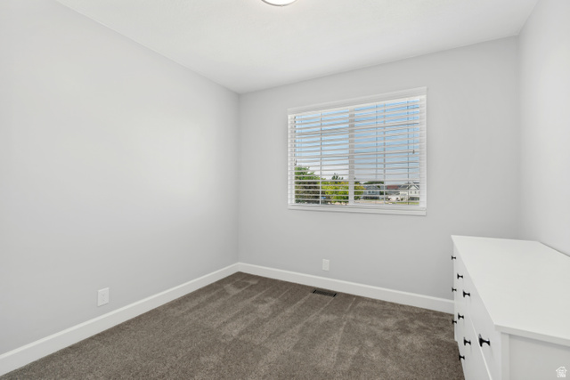 4752 South 4075th Street West Roy, UT 84067 - Photo 16 of 28 Interior room featuring light gray walls, dark gray carpet flooring, and white trim
