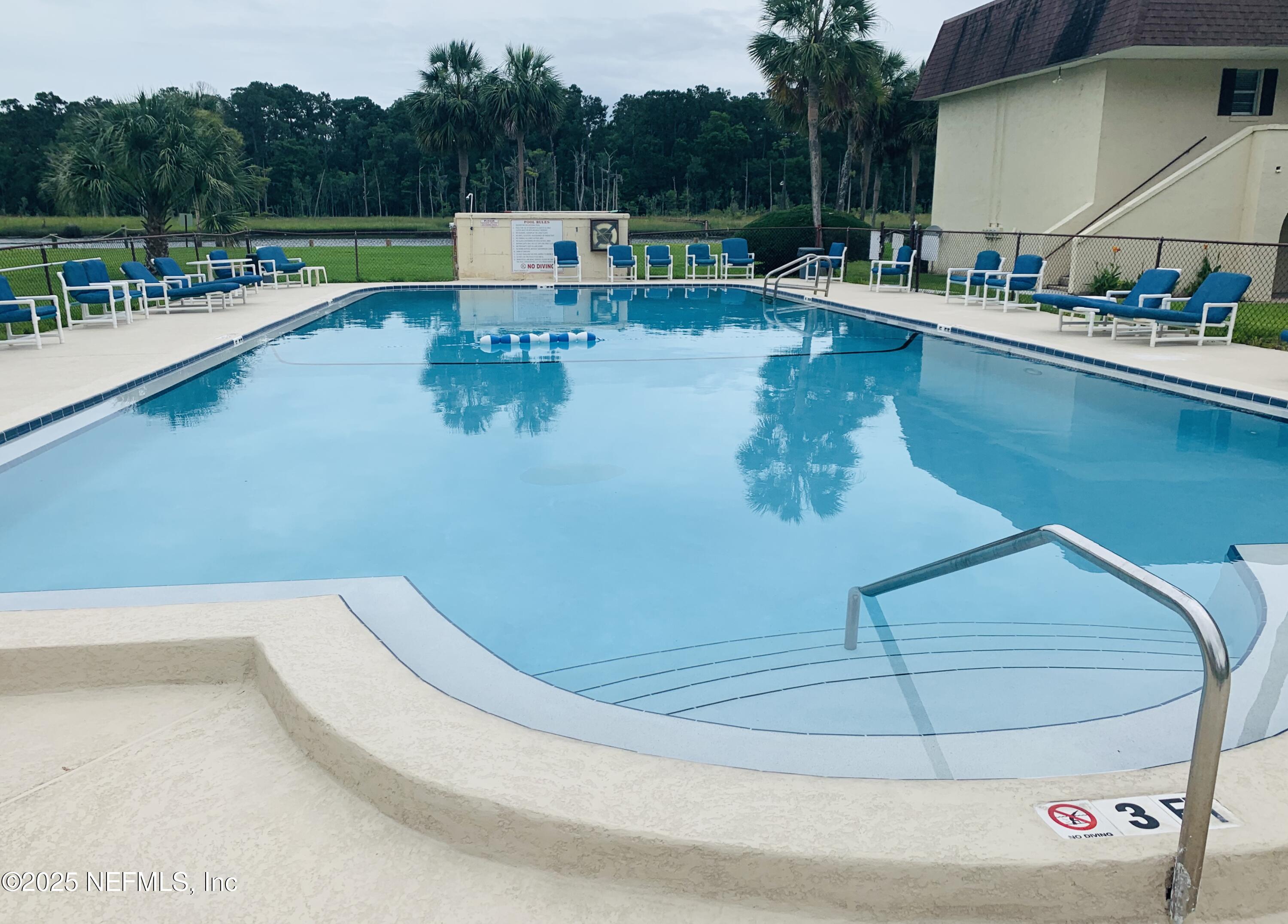 1707 El Prado Road, Unit 3 Jacksonville, FL 32216 - Photo 22 of 24 a view of a swimming pool with a patio and a yard