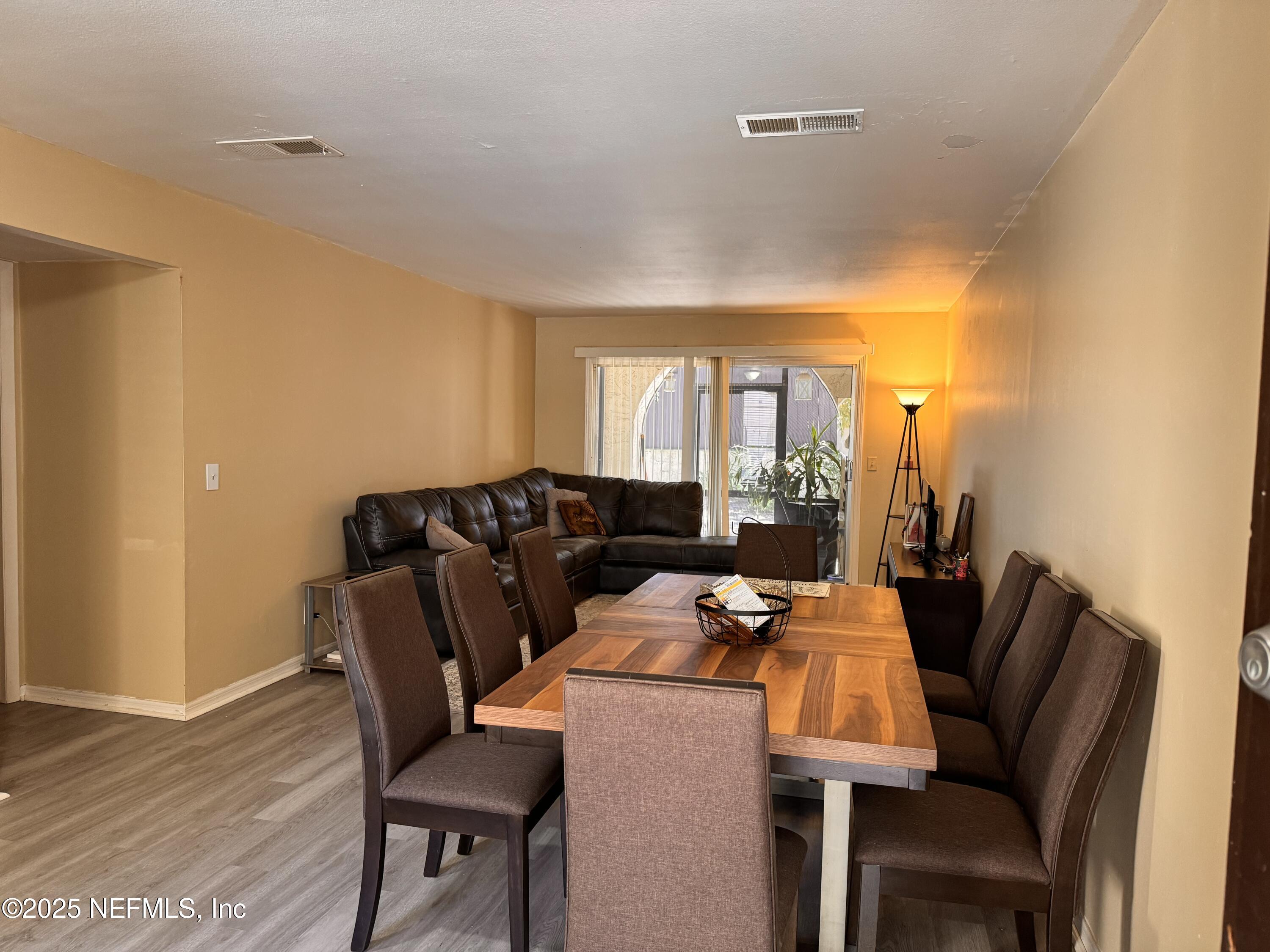 1707 El Prado Road, Unit 3 Jacksonville, FL 32216 - Photo 3 of 24 a view of a dining room with furniture and wooden floor