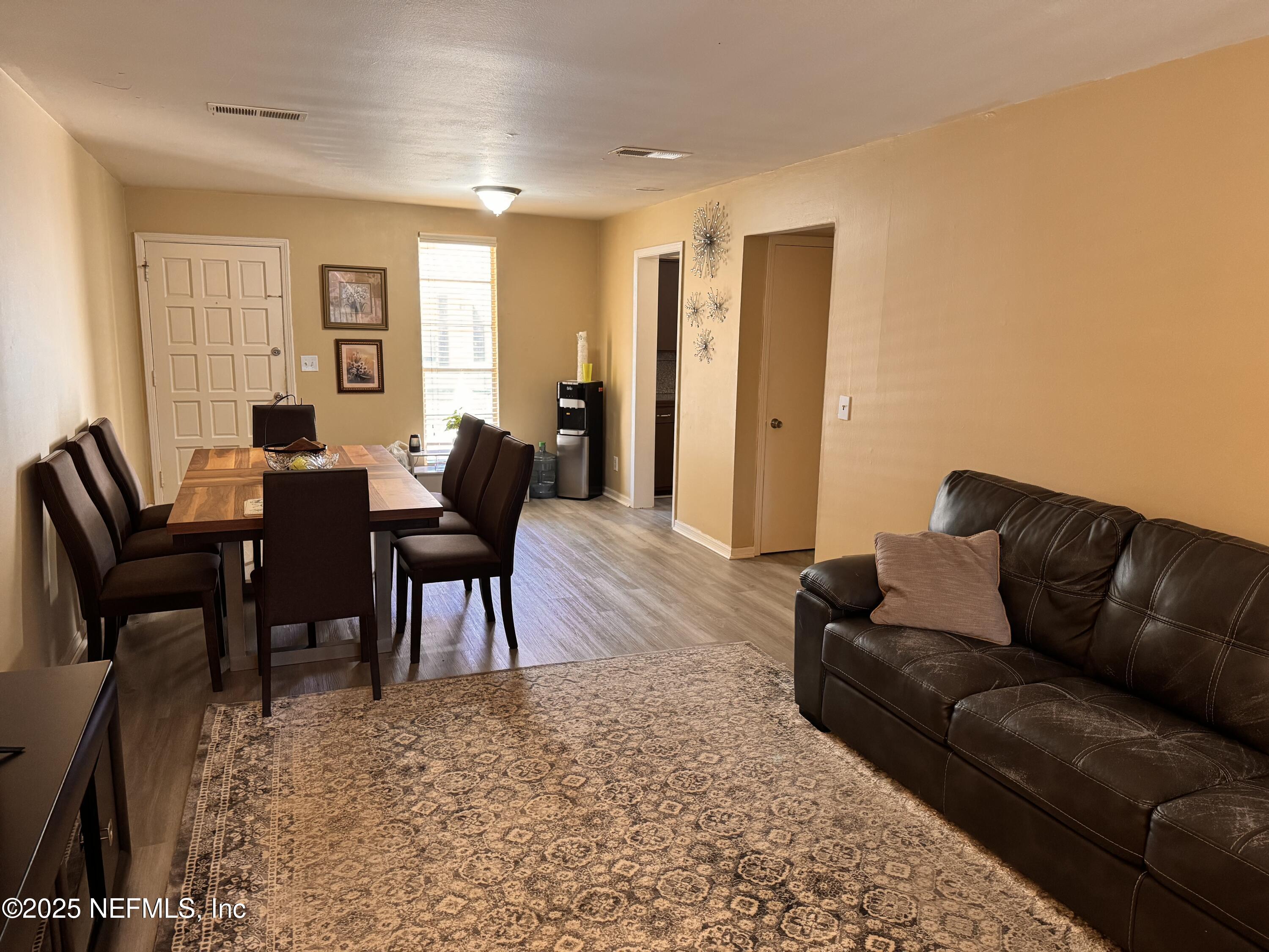 1707 El Prado Road, Unit 3 Jacksonville, FL 32216 - Photo 5 of 24 a living room with furniture and a dining table
