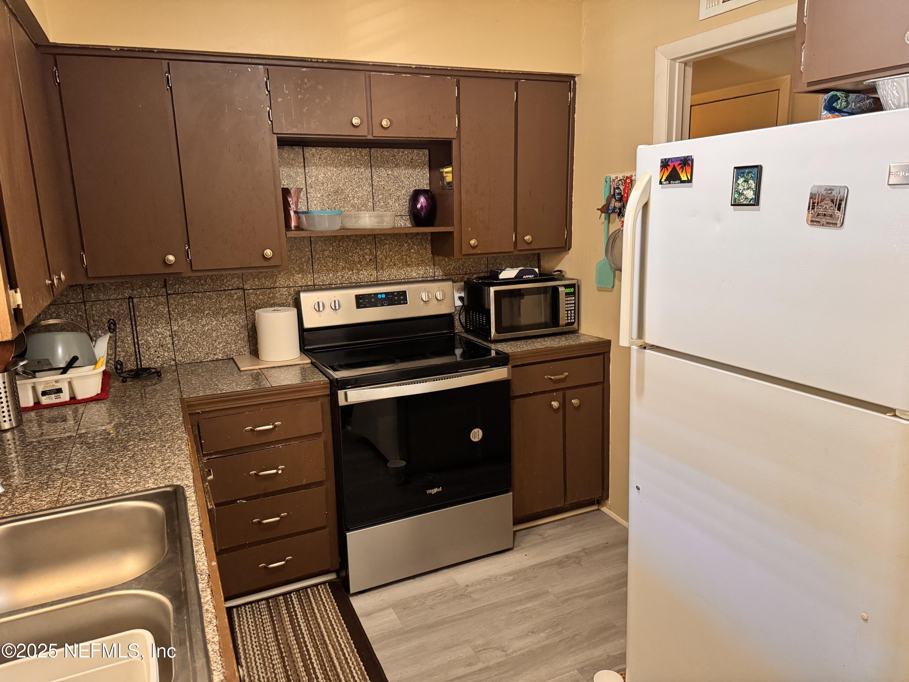 1707 El Prado Road, Unit 3 Jacksonville, FL 32216 - Photo 7 of 24 a kitchen with a refrigerator and a stove