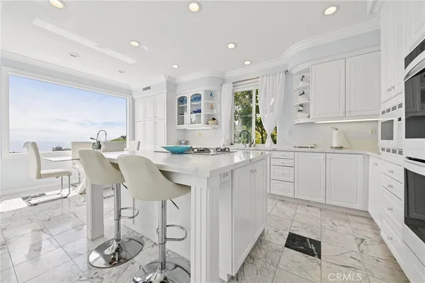 a kitchen with stainless steel appliances granite countertop a sink and cabinets
