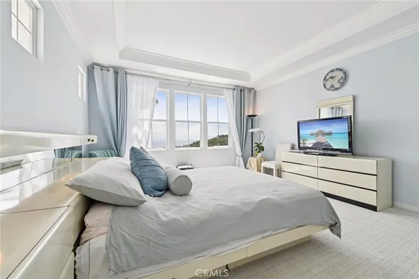 a bedroom with furniture and a flat screen tv