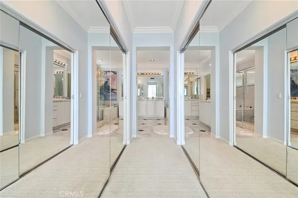 a view of a hallway with large glass door and chandelier