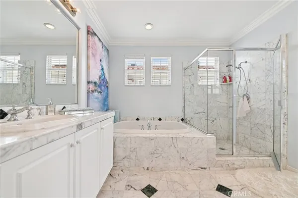 a bathroom with a tub sink mirror and a shower