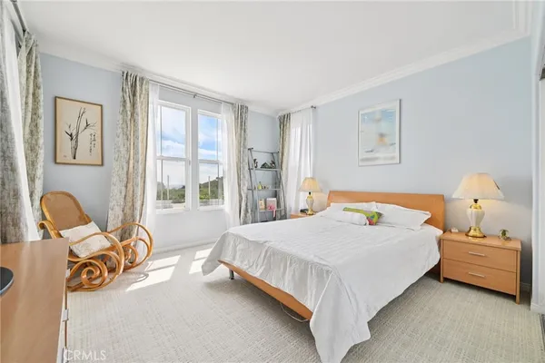 a bedroom with a bed chair and window