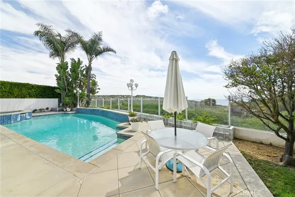 a view of a swimming pool with a lounge chairs