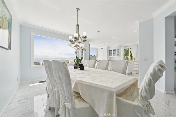 a view of a dining room with furniture and chandelier