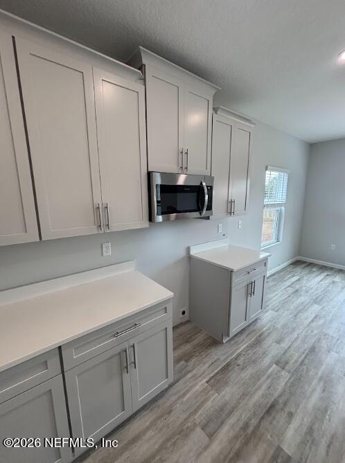 8614 Crystalline Lane Jacksonville, FL 32221 - Photo 3 of 20 a kitchen with a sink cabinets and wooden floor