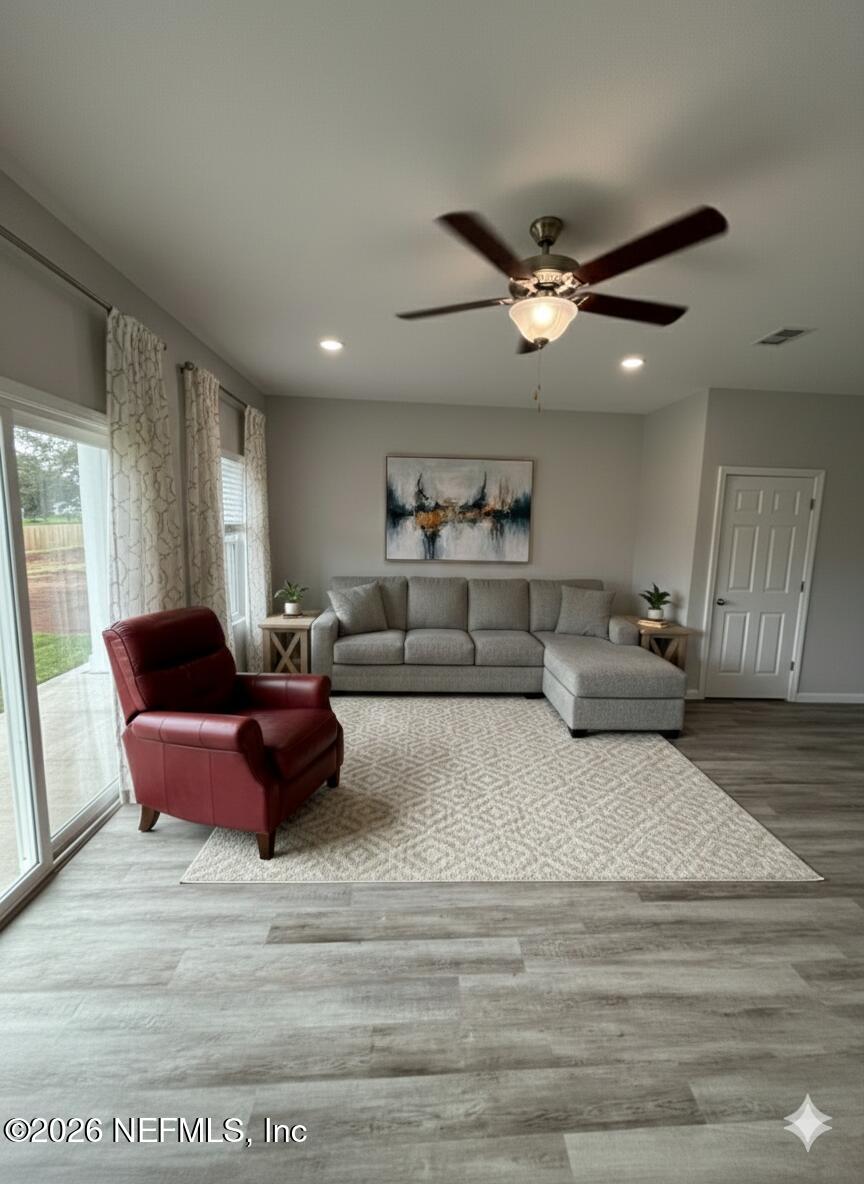 8614 Crystalline Lane Jacksonville, FL 32221 - Photo 4 of 20 a living room with furniture and a ceiling fan