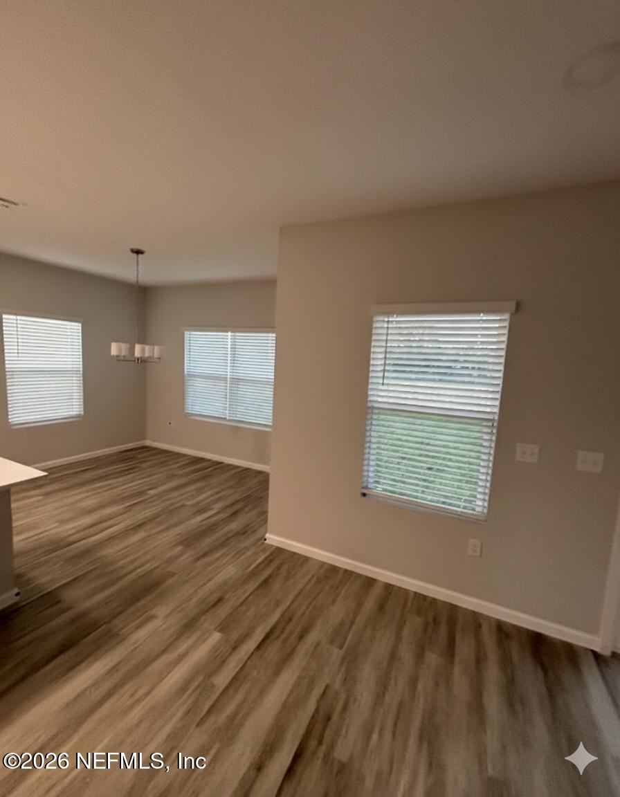 8614 Crystalline Lane Jacksonville, FL 32221 - Photo 7 of 20 an empty room with wooden floor and windows