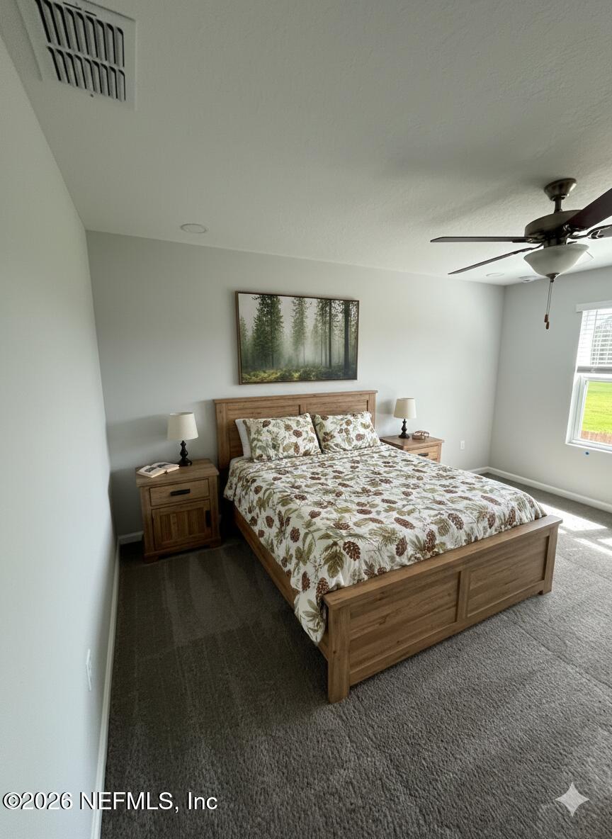 8614 Crystalline Lane Jacksonville, FL 32221 - Photo 8 of 20 a bedroom with a bed and a couch