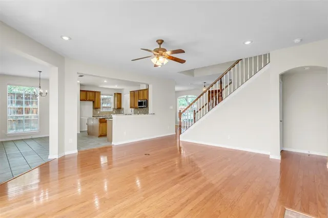 a view of a kitchen with wooden floor and a ceiling fan