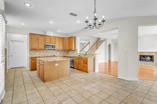 a kitchen with stainless steel appliances granite countertop a sink and cabinets