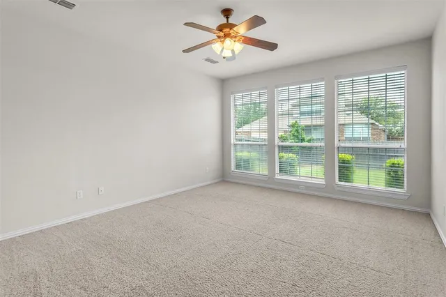 a view of a room with a window and a fan