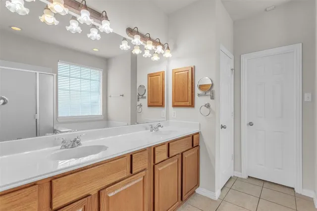a bathroom with a granite countertop sink a large mirror and a shower