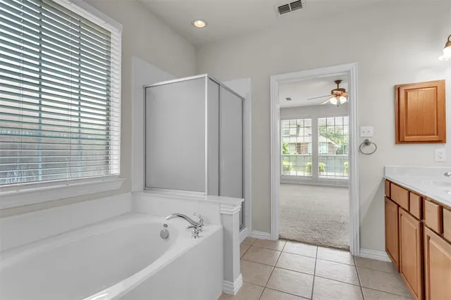 a bathroom with a bathtub and a shower
