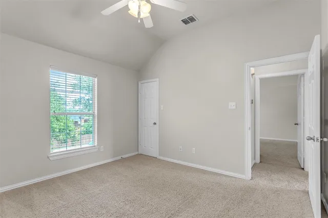 an empty room with windows and closet
