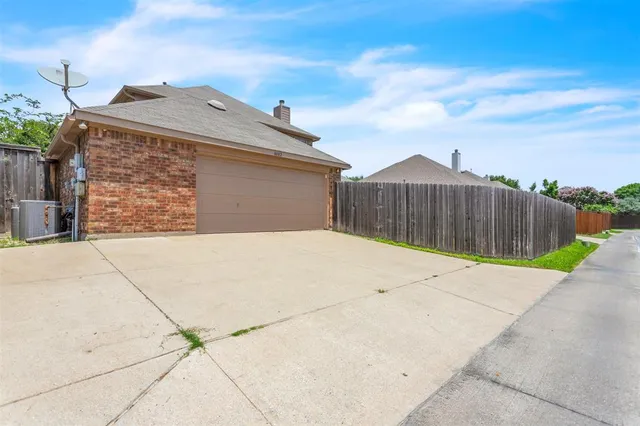 a view of a backyard with a wooden fence