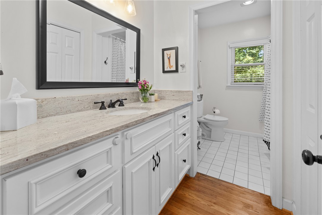 203 Augusta Road Clemson, SC 29631 - Photo 18 of 31 White cabinetry and granite counters complement the light, airy design of this well-appointed hall bathroom.