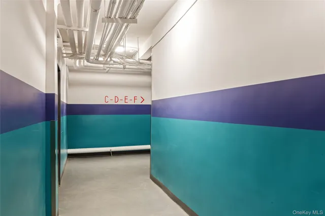a view of a hallway with wooden floor and a dining table
