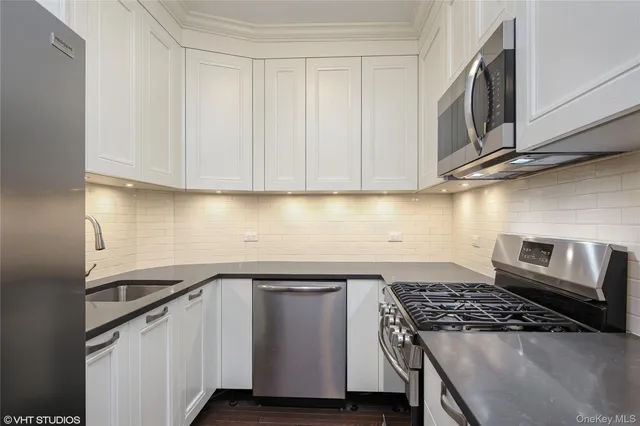a kitchen with wooden cabinets and a stove top oven