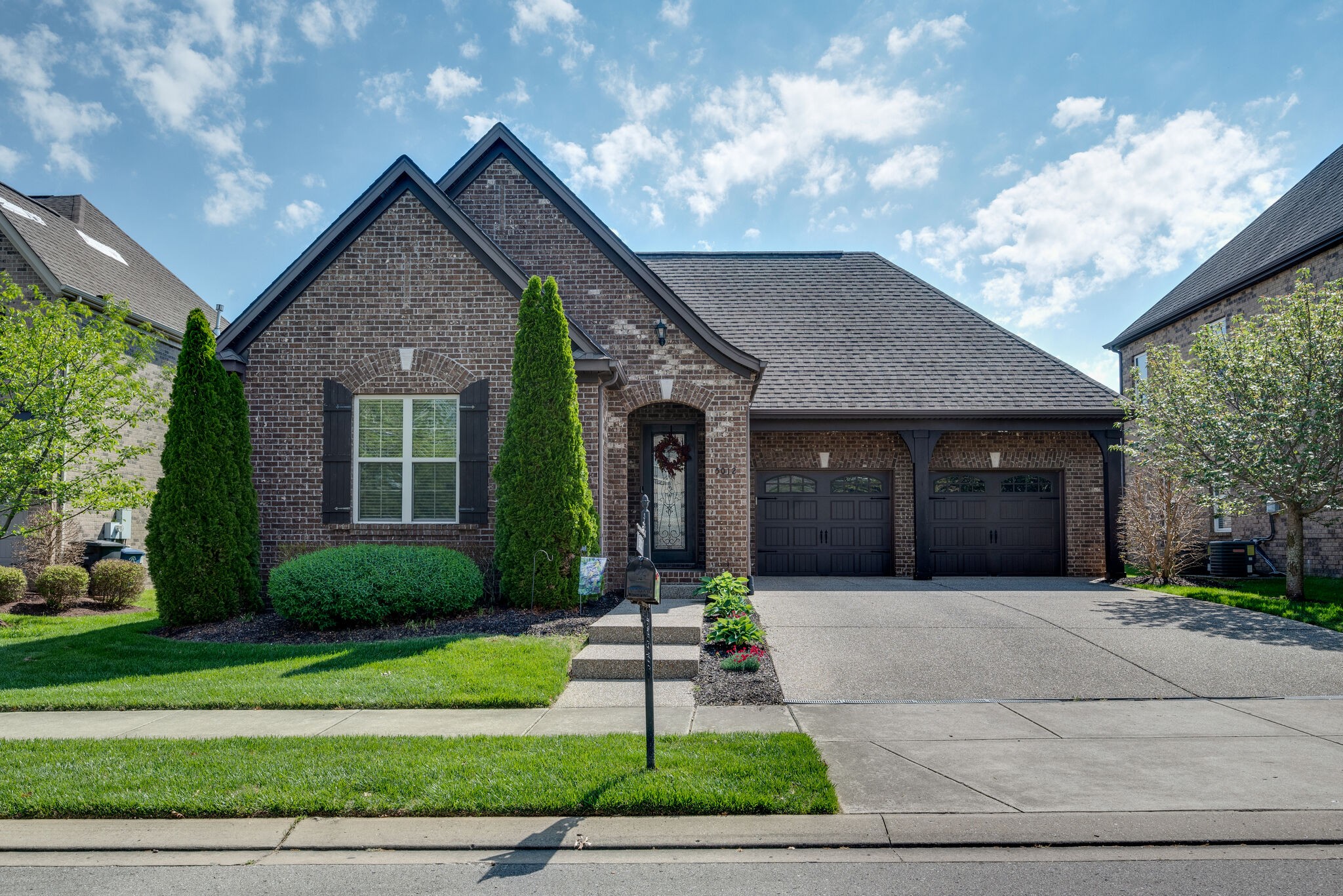 5012 Rizer Point Drive Franklin, TN 37069 - Photo 1 of 38 a front view of a house with a garden and plants