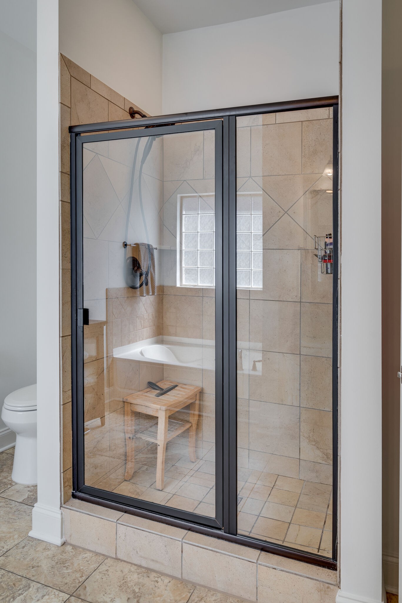5012 Rizer Point Drive Franklin, TN 37069 - Photo 20 of 38 a bathroom with a glass shower door