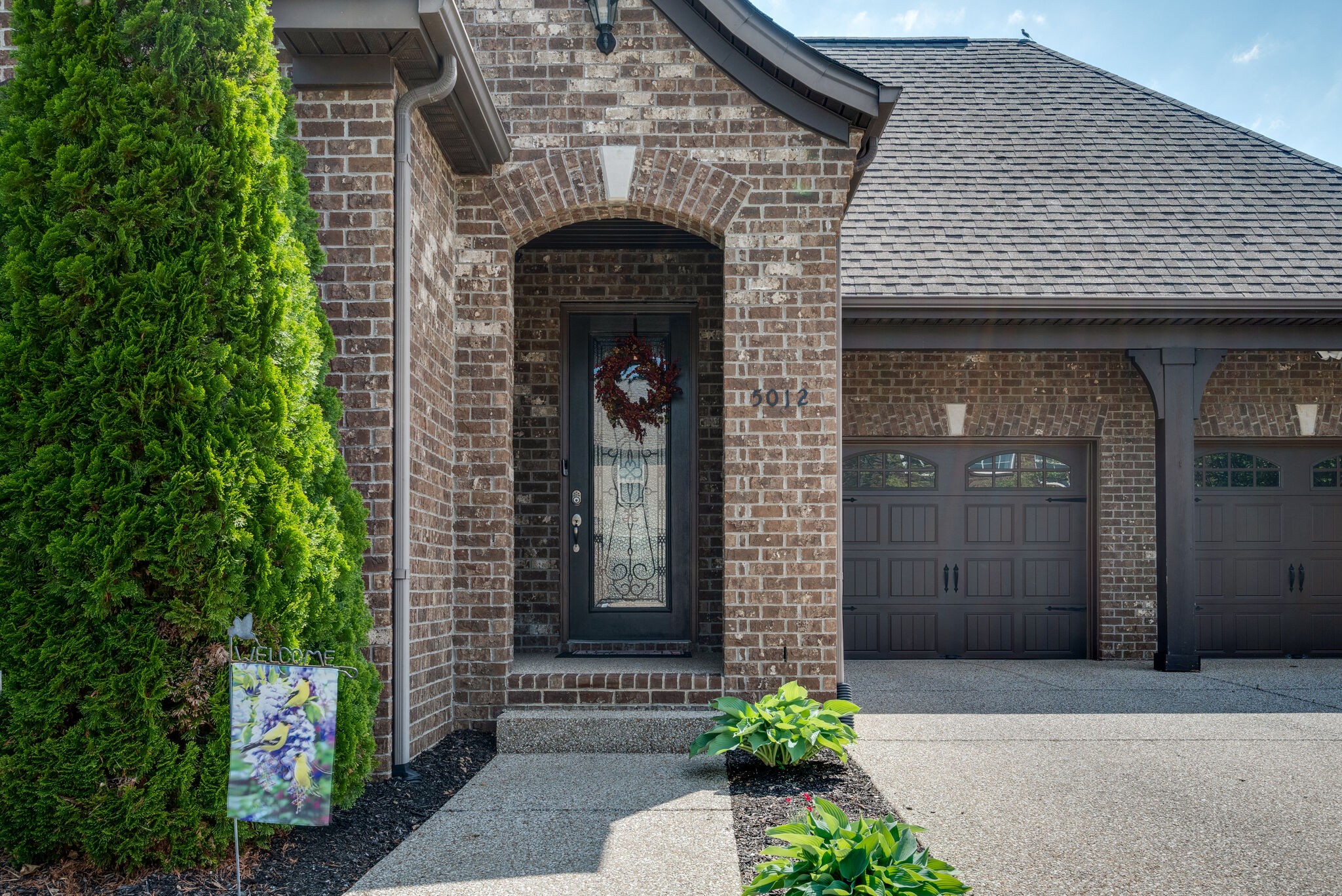 5012 Rizer Point Drive Franklin, TN 37069 - Photo 3 of 38 a front view of a house with a garden