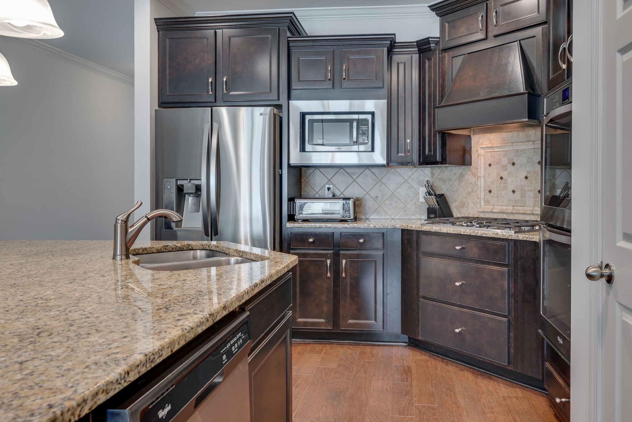 5012 Rizer Point Drive Franklin, TN 37069 - Photo 7 of 38 a kitchen with stainless steel appliances granite countertop a sink stove and refrigerator