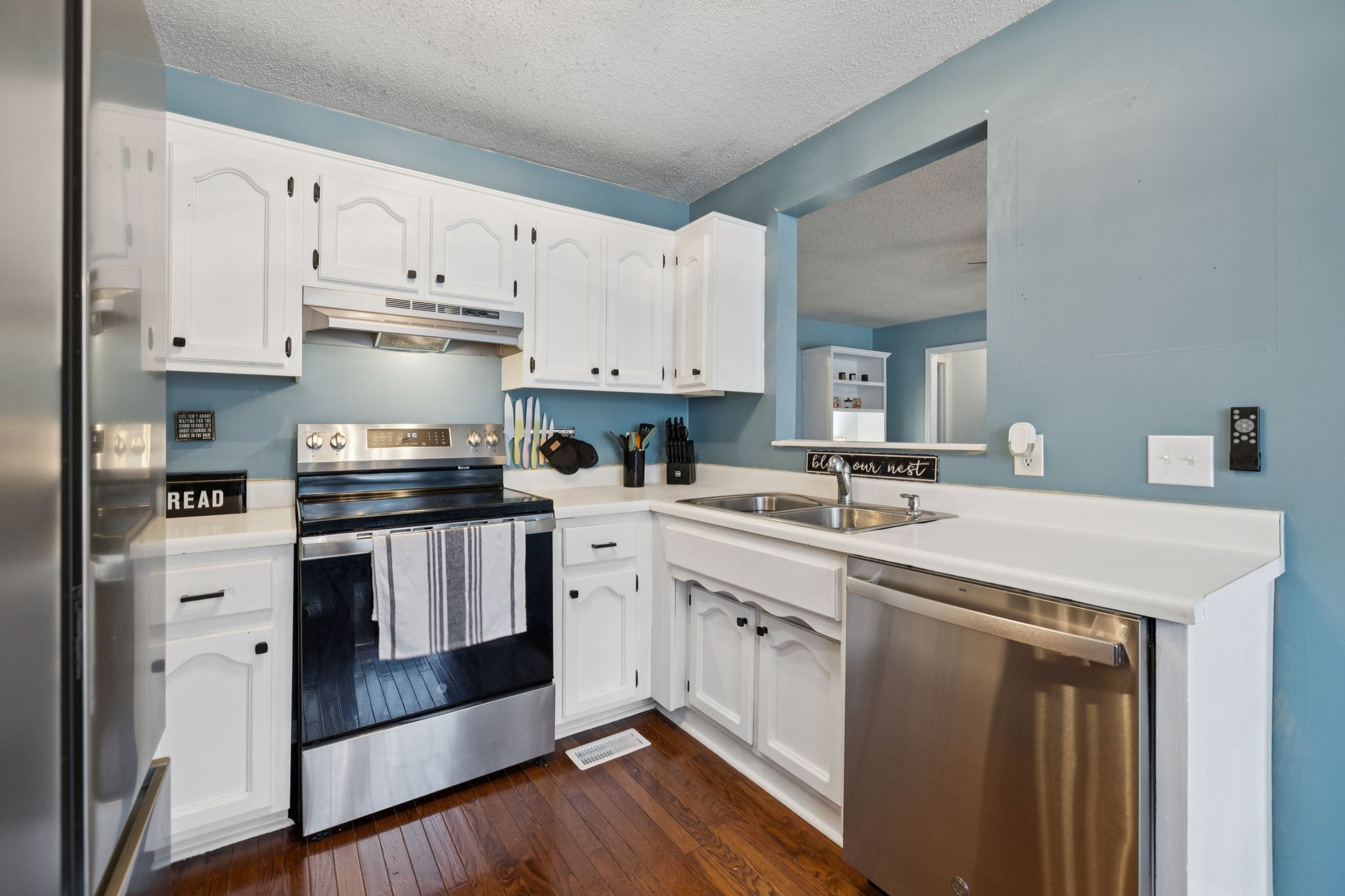 1016 Keystone Drive Pleasant View, TN 37146 - Photo 11 of 33 a kitchen with stainless steel appliances granite countertop a white cabinets and sink