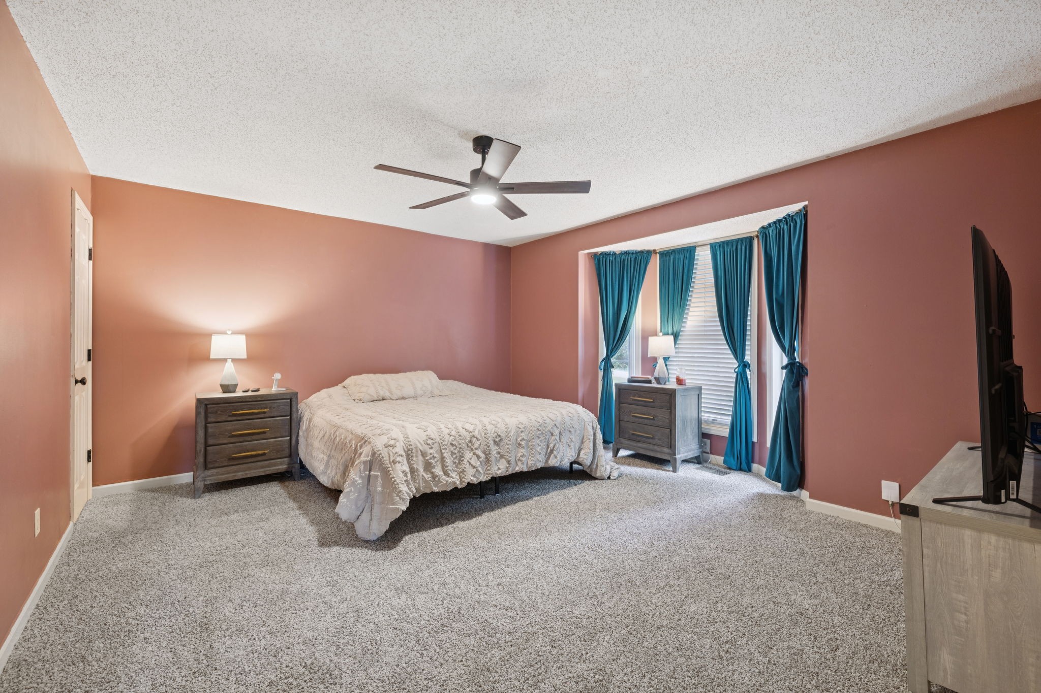 1016 Keystone Drive Pleasant View, TN 37146 - Photo 12 of 33 a spacious bedroom with a bed and a chandelier
