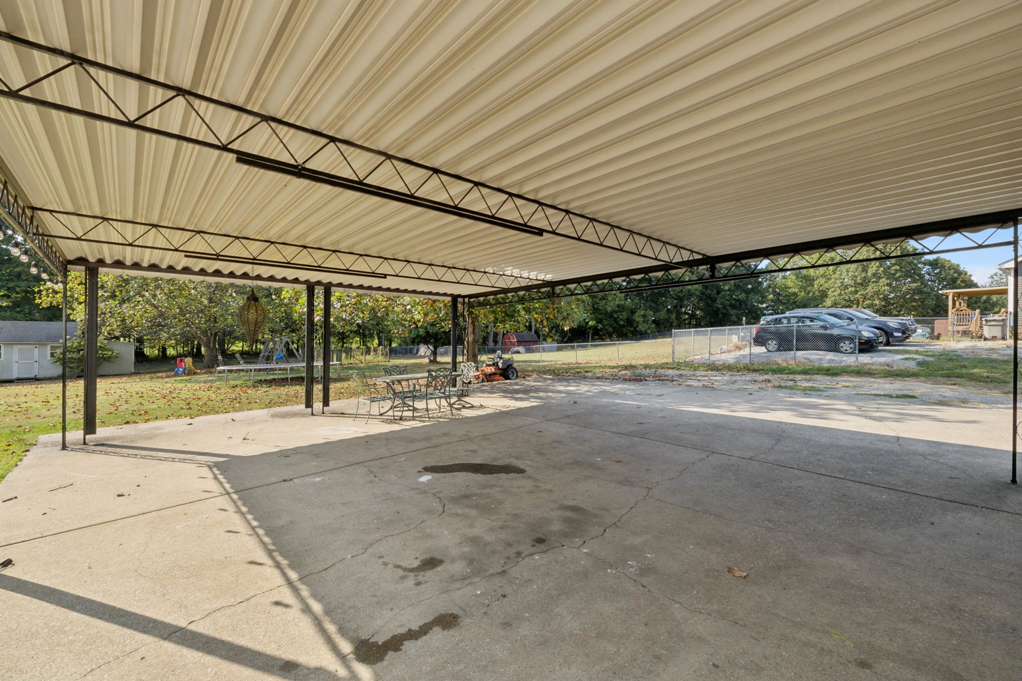 1016 Keystone Drive Pleasant View, TN 37146 - Photo 25 of 33 a view of a patio with table and chairs under an umbrella