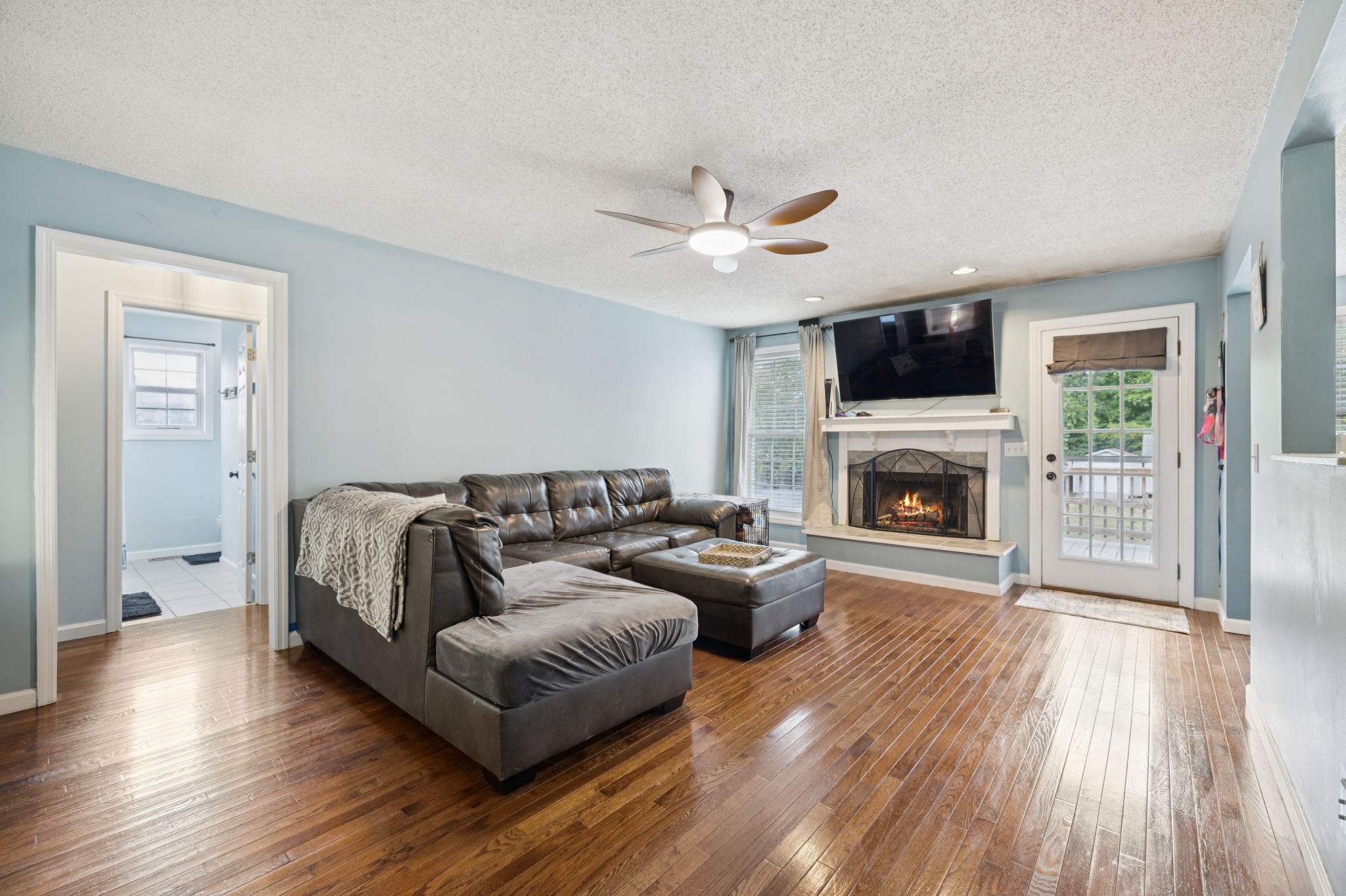 1016 Keystone Drive Pleasant View, TN 37146 - Photo 6 of 33 a living room with furniture a flat screen tv and a fireplace