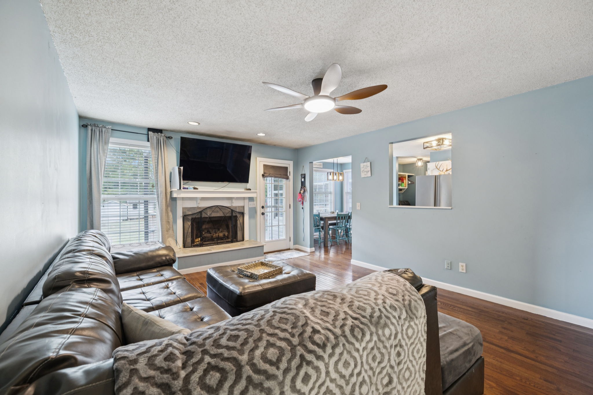 1016 Keystone Drive Pleasant View, TN 37146 - Photo 7 of 33 a living room with furniture a flat screen tv and a fireplace