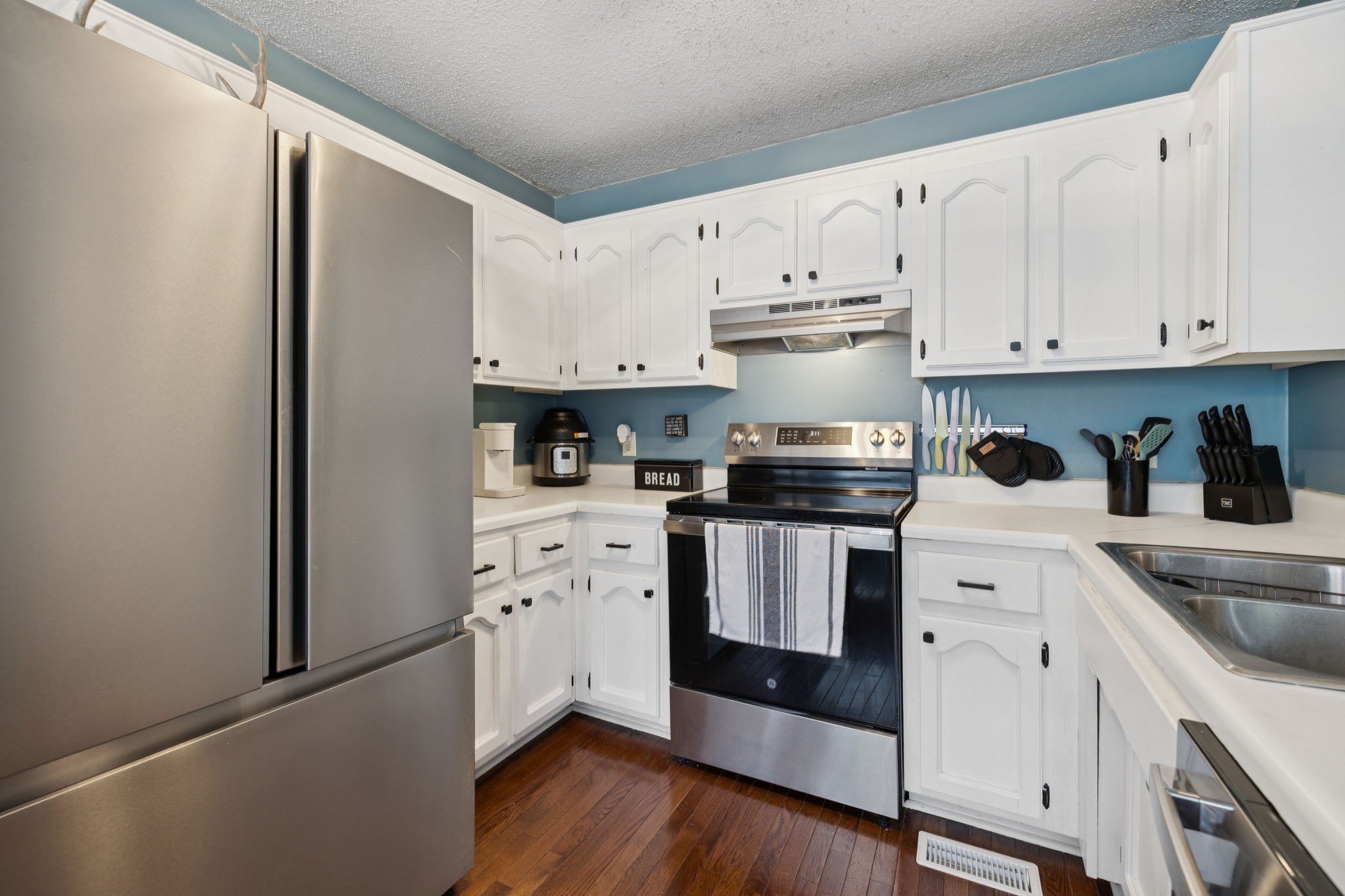 1016 Keystone Drive Pleasant View, TN 37146 - Photo 10 of 33 a kitchen with white cabinets and white appliances
