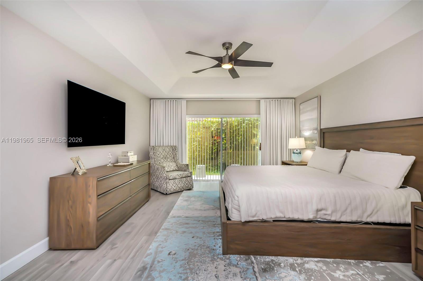 11030 Harbour Springs Circle Boca Raton, FL 33428 - Photo 11 of 39 a bedroom with a bed and a flat screen tv