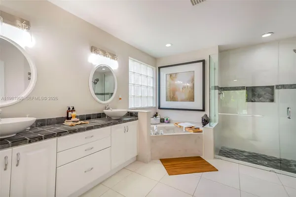 a bathroom with a sink a mirror and a bathtub