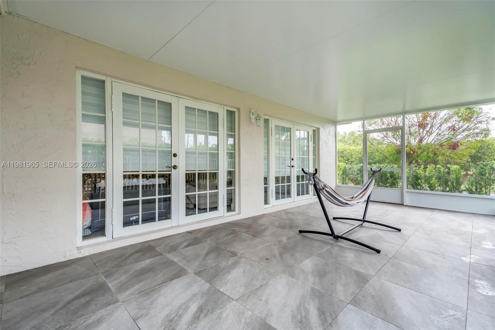 11030 Harbour Springs Circle Boca Raton, FL 33428 - Photo 16 of 39 a living room with furniture and a floor to ceiling window