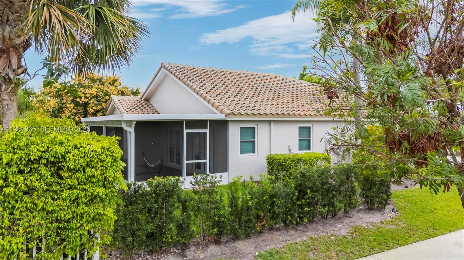 11030 Harbour Springs Circle Boca Raton, FL 33428 - Photo 19 of 39 a front view of a house with a garden