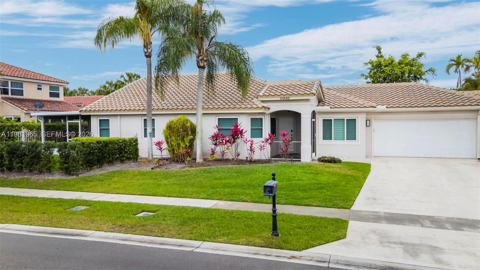11030 Harbour Springs Circle Boca Raton, FL 33428 - Photo 21 of 39 a front view of a house with garden